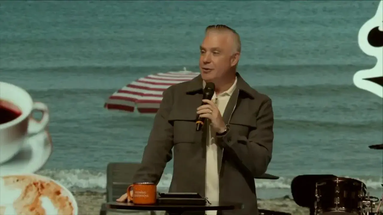 Pastor Ben Pierce speaking center stage with 'Hear me out' logo and beach backdrop